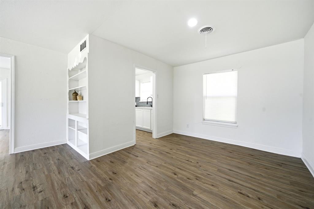 619 9th Street Terrell, TX 75160 - Photo 6 of 24 an empty room with wooden floor and windows
