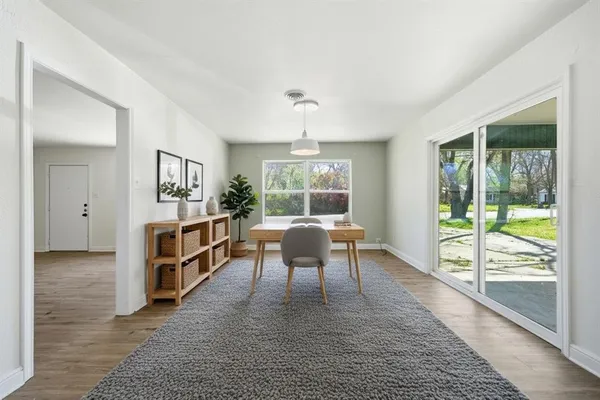 a dining room with furniture a chandelier and wooden floor