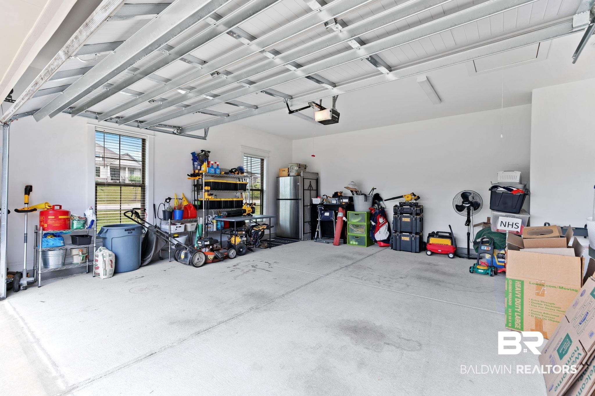 13233 Ibis Boulevard Daphne, AL 36527 - Photo 76 of 100 Spacious two-car garage with concrete flooring