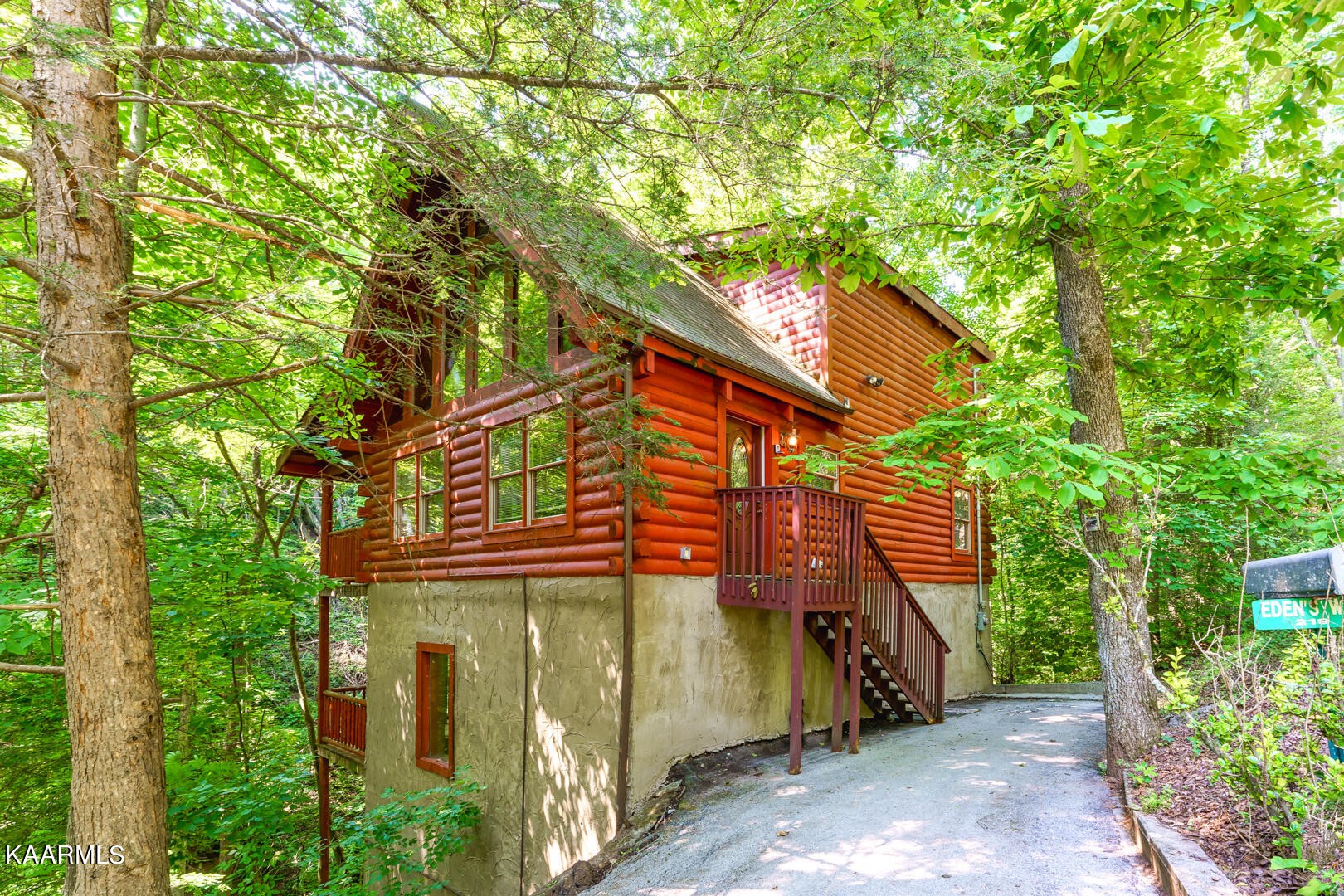a yellow house with a tree in front of it