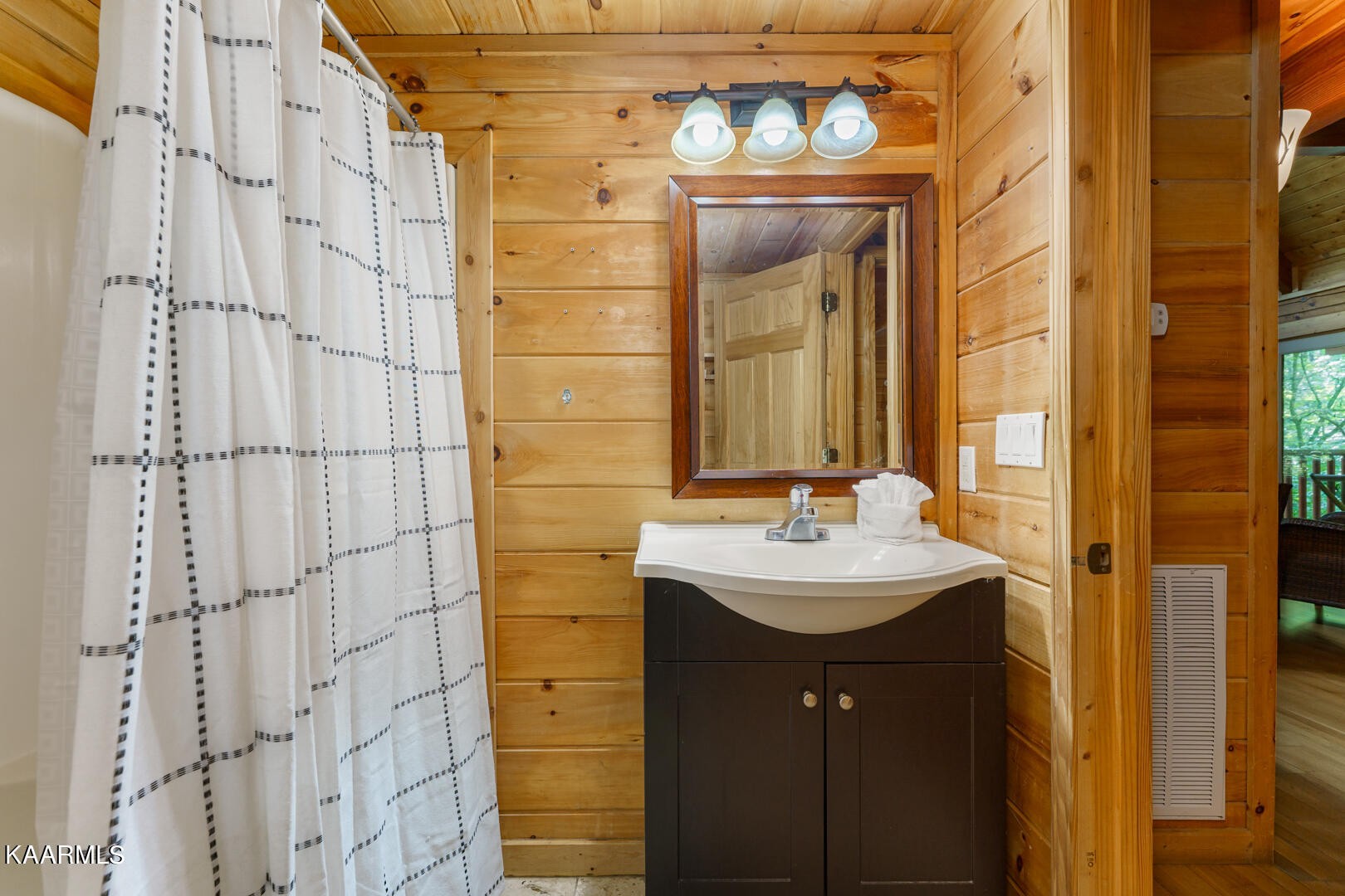 219 Edens Way Sevierville, TN 37876 - Photo 11 of 29 a bathroom with a sink a mirror and shower