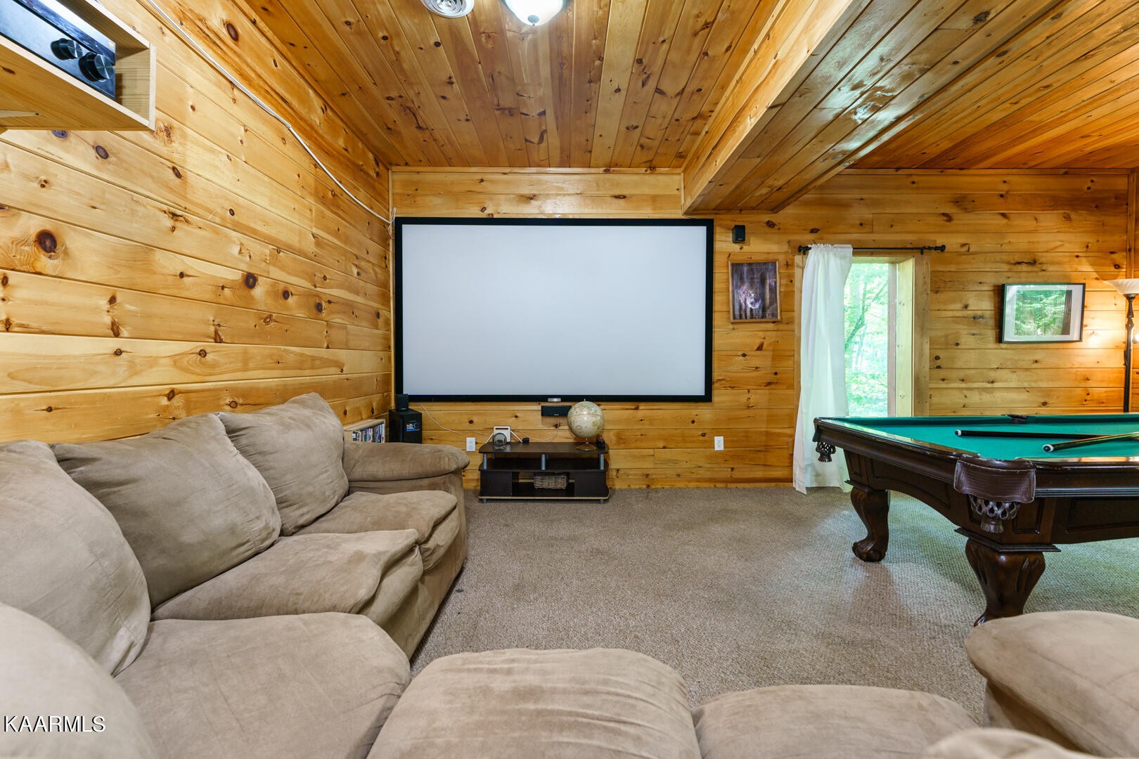 219 Edens Way Sevierville, TN 37876 - Photo 17 of 29 a living room with furniture and a projector