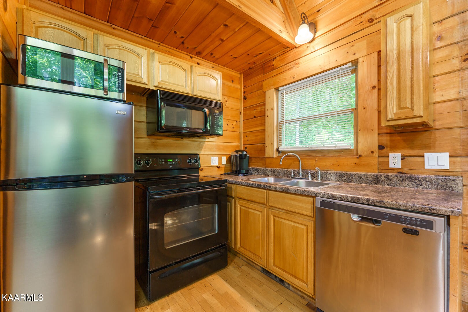 219 Edens Way Sevierville, TN 37876 - Photo 8 of 29 a kitchen with stainless steel appliances granite countertop a refrigerator a sink dishwasher a stove and a microwave oven with cabinets