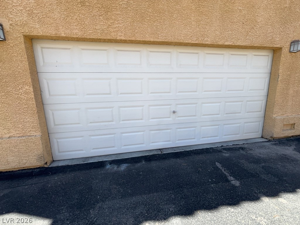 4915 East Russell Road, Unit 154 Las Vegas, NV 89120 - Photo 20 of 20 An attached two-car garage features a classic paneled door set against a stucco exterior.