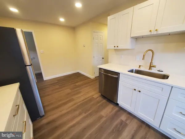 a kitchen with cabinets a sink and appliances