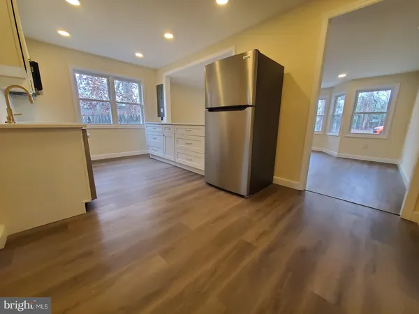 a view of a refrigerator in kitchen and wooden floor