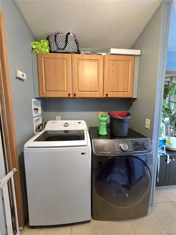 a utility room with stainless steel appliances granite countertop a washer and dryer