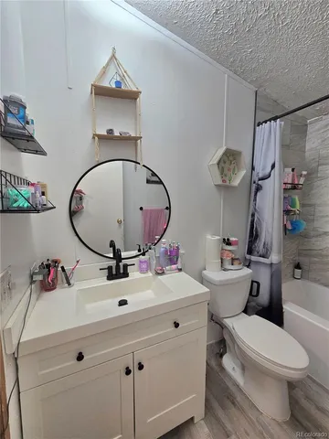 a bathroom with a sink mirror toilet and shower