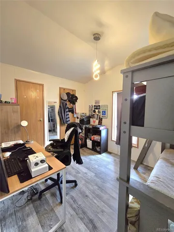 a bedroom with furniture and a gym equipment