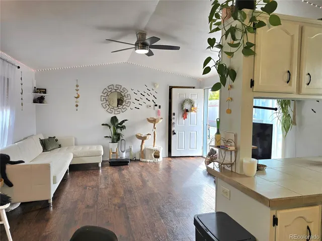 a living room with furniture and wooden floor