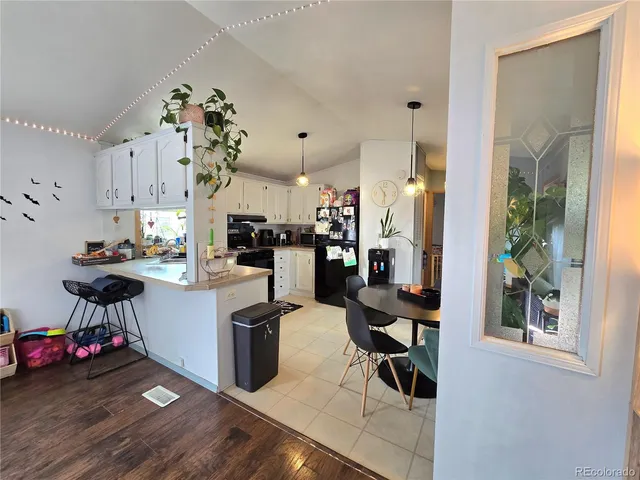 a living room with stainless steel appliances kitchen island granite countertop furniture and a view of kitchen