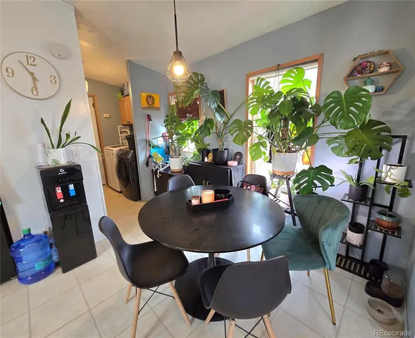 a view of a dining room with furniture and potted plant