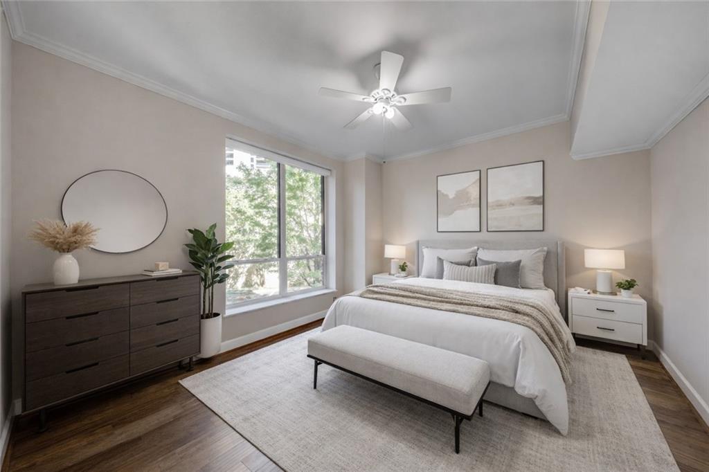 2626 Peachtree Road Northwest, Unit 412 Atlanta, GA 30305 - Photo 19 of 38 a bedroom with a large bed and wooden floor