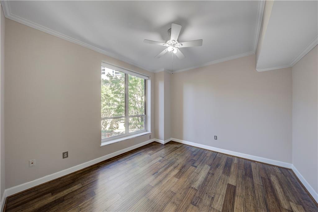 2626 Peachtree Road Northwest, Unit 412 Atlanta, GA 30305 - Photo 20 of 38 a view of an empty room with wooden floor and a window