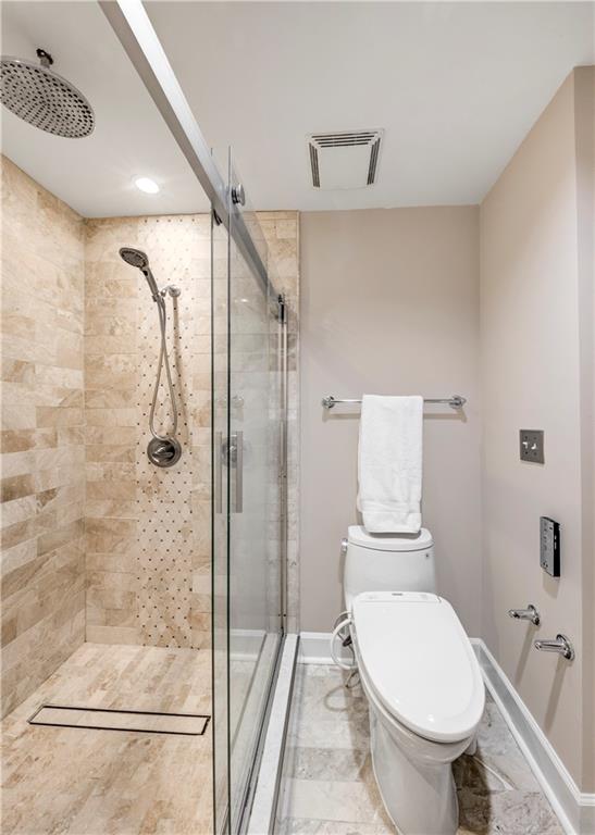 2626 Peachtree Road Northwest, Unit 412 Atlanta, GA 30305 - Photo 24 of 38 a bathroom with a toilet and a shower