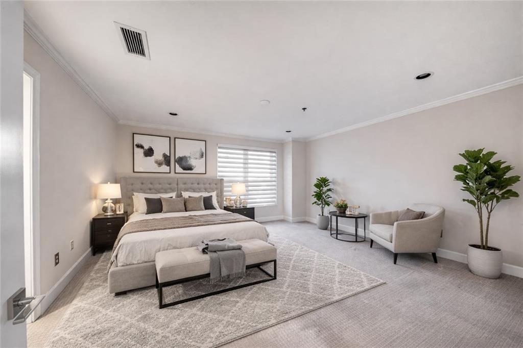 2626 Peachtree Road Northwest, Unit 412 Atlanta, GA 30305 - Photo 26 of 38 a bedroom with a bed and a potted plant