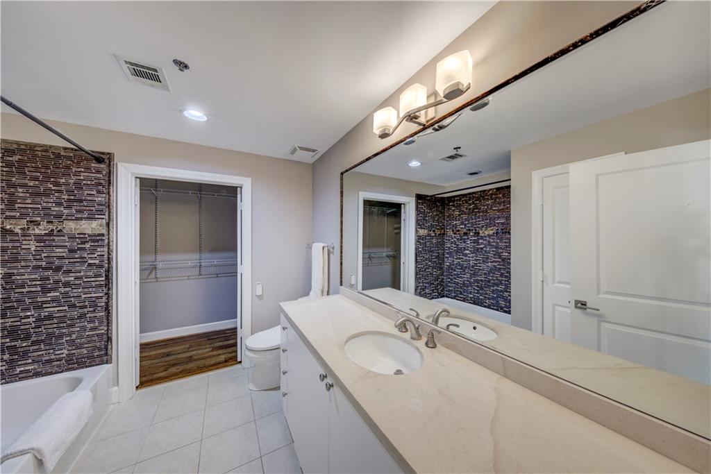2626 Peachtree Road Northwest, Unit 412 Atlanta, GA 30305 - Photo 28 of 38 a bathroom with a double vanity sink a toilet and shower