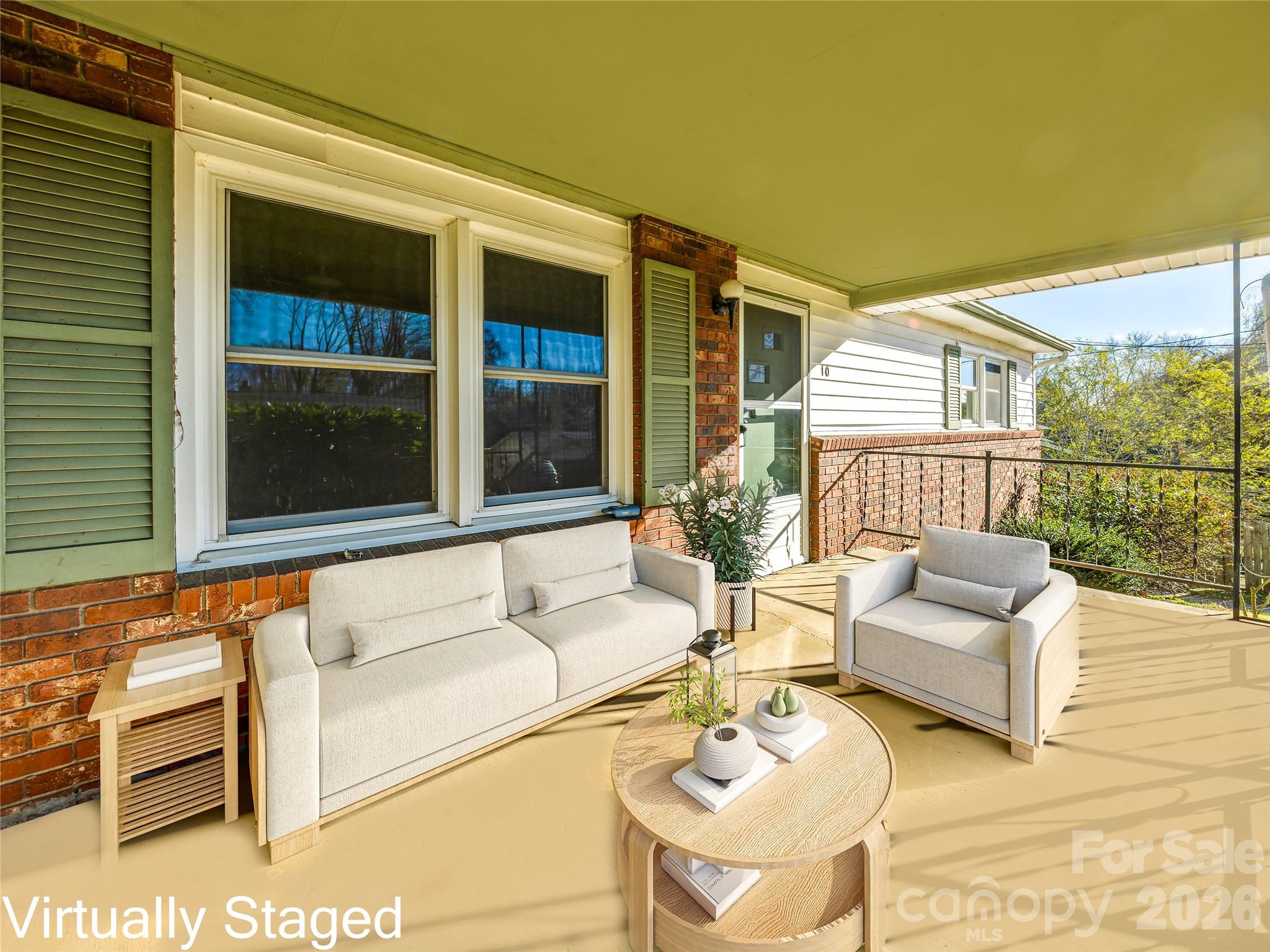 10 Ridge Avenue Asheville, NC 28803 - Photo 1 of 33 a balcony with furniture and a potted plant