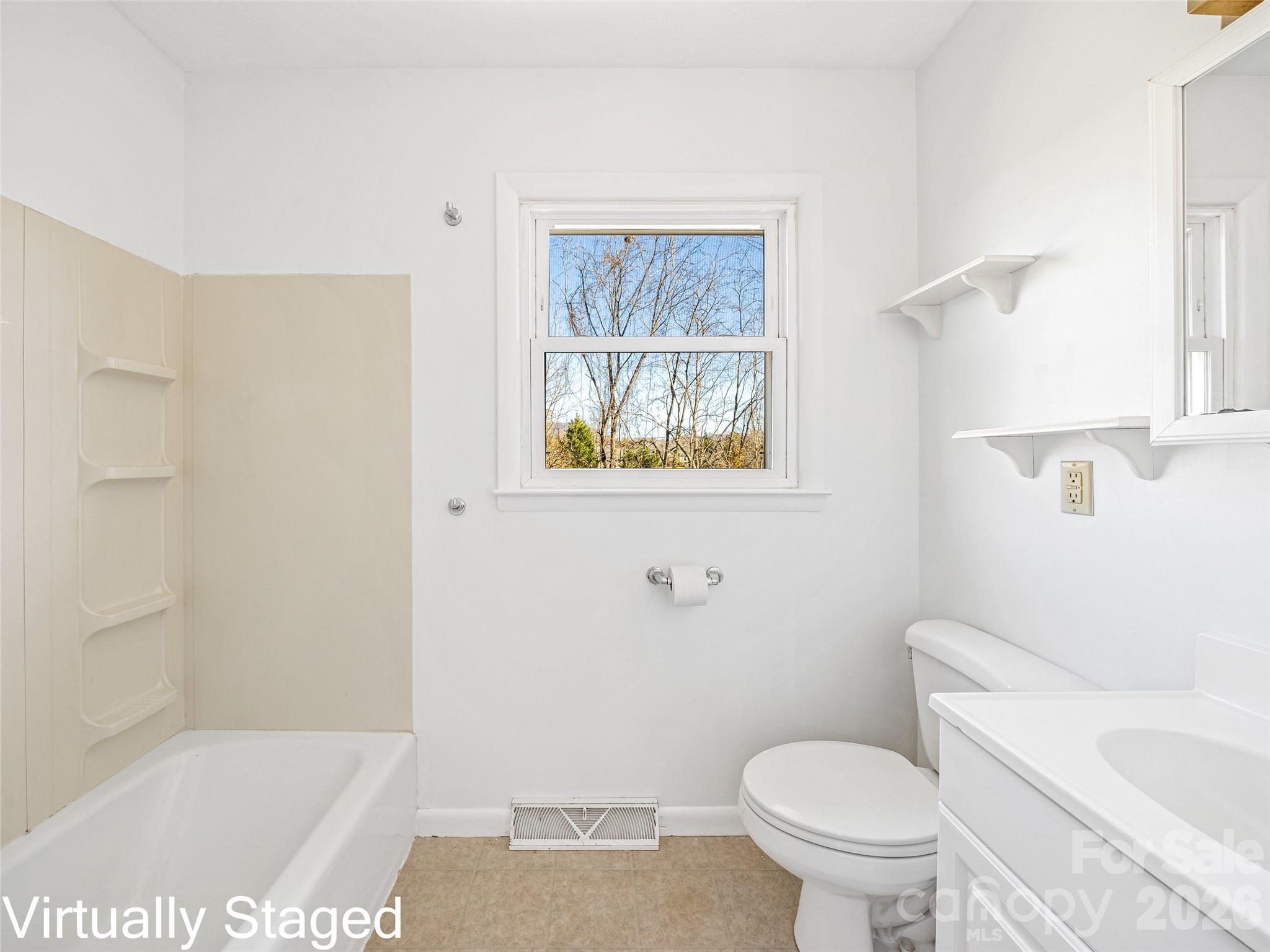 10 Ridge Avenue Asheville, NC 28803 - Photo 16 of 33 a white toilet sitting next to a bath tub shower