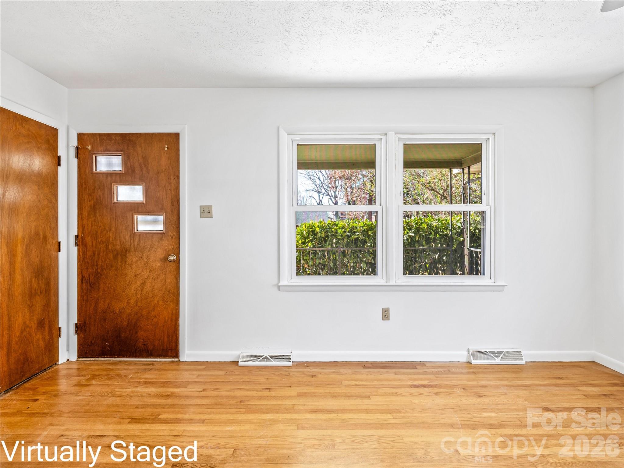 10 Ridge Avenue Asheville, NC 28803 - Photo 7 of 33 a view of an empty room with window and a kitchen
