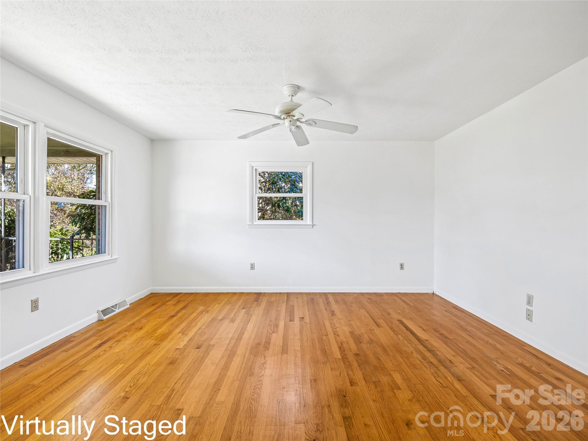 10 Ridge Avenue Asheville, NC 28803 - Photo 8 of 33 an empty room with a window and a ceiling fan