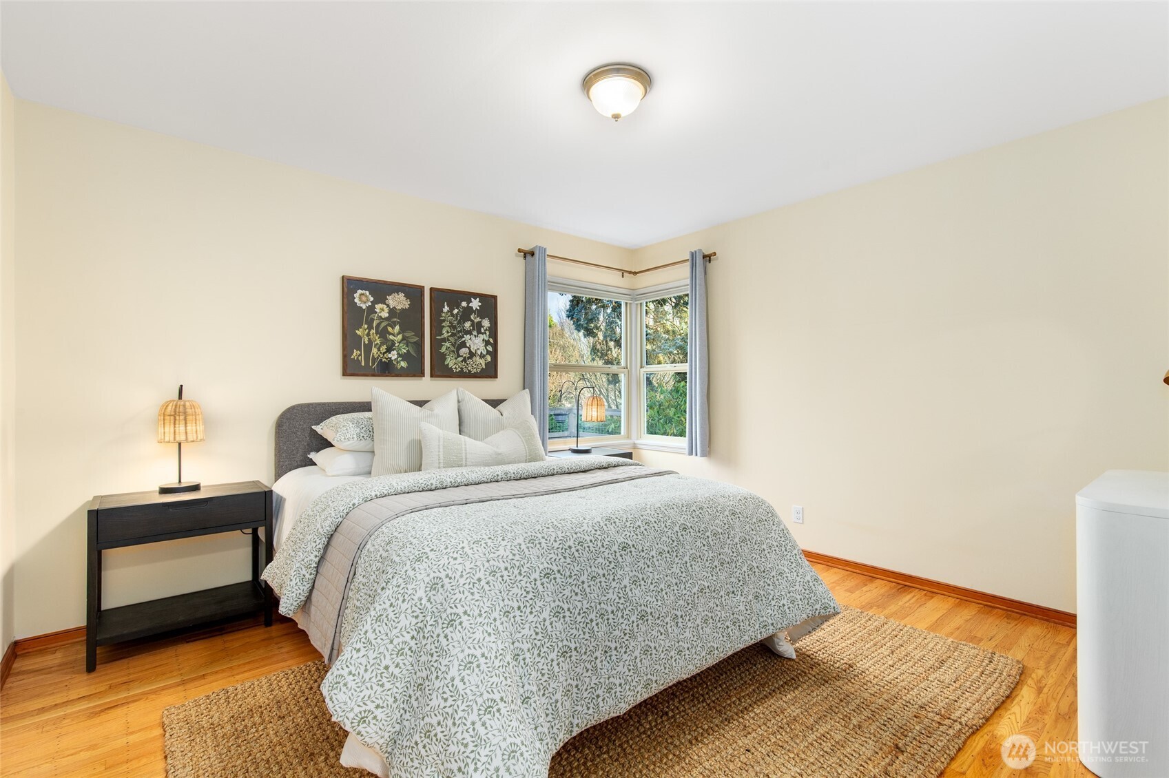 8625 35th Avenue Southwest Seattle, WA 98126 - Photo 12 of 33 a bedroom with a bed and wooden floor