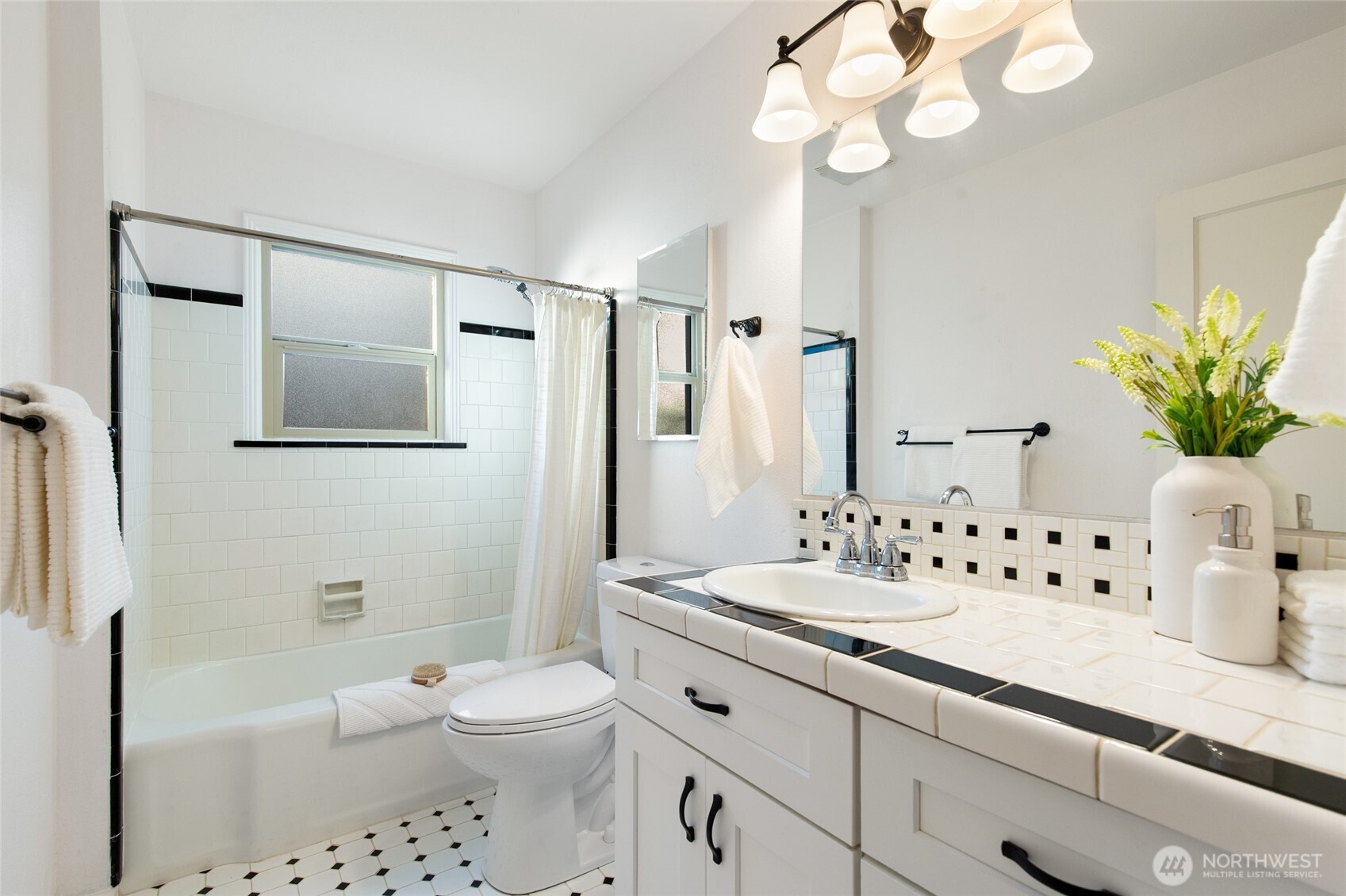 8625 35th Avenue Southwest Seattle, WA 98126 - Photo 14 of 33 a bathroom with a sink a toilet and a large mirror