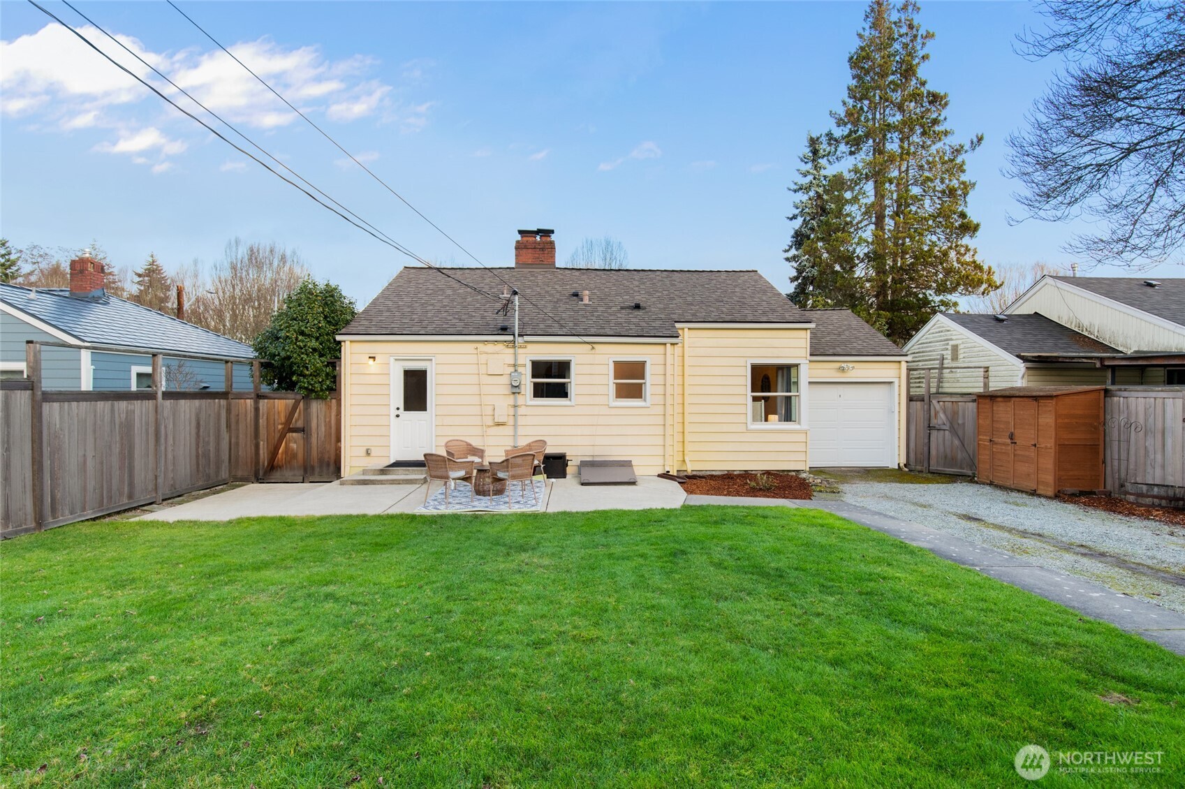 8625 35th Avenue Southwest Seattle, WA 98126 - Photo 24 of 33 a front view of a house with a yard and garage