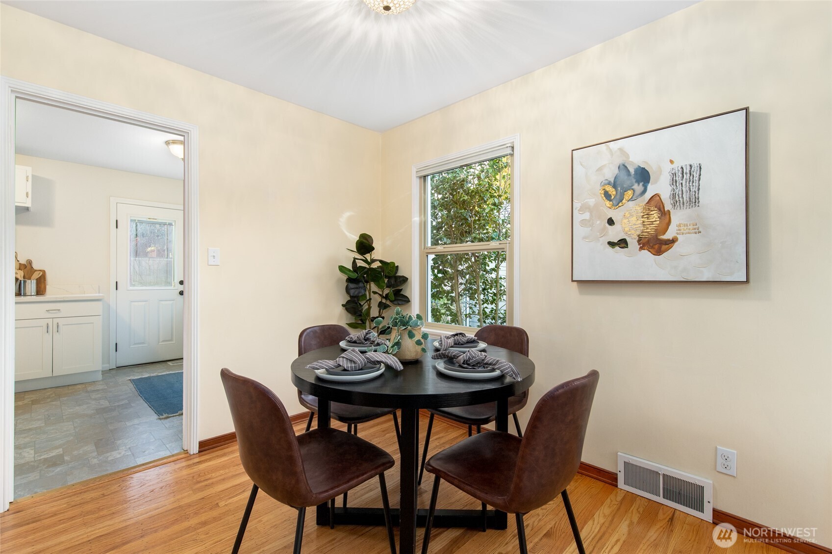 8625 35th Avenue Southwest Seattle, WA 98126 - Photo 7 of 33 a view of a dining room with furniture and wooden floor