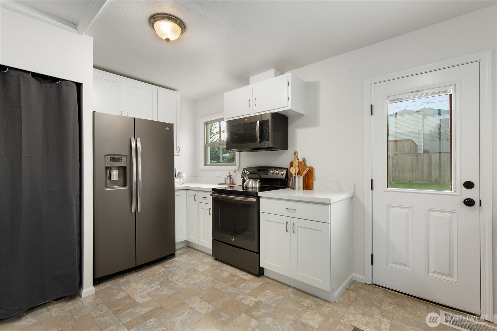 8625 35th Avenue Southwest Seattle, WA 98126 - Photo 8 of 33 a kitchen with stainless steel appliances granite countertop a refrigerator stove and sink