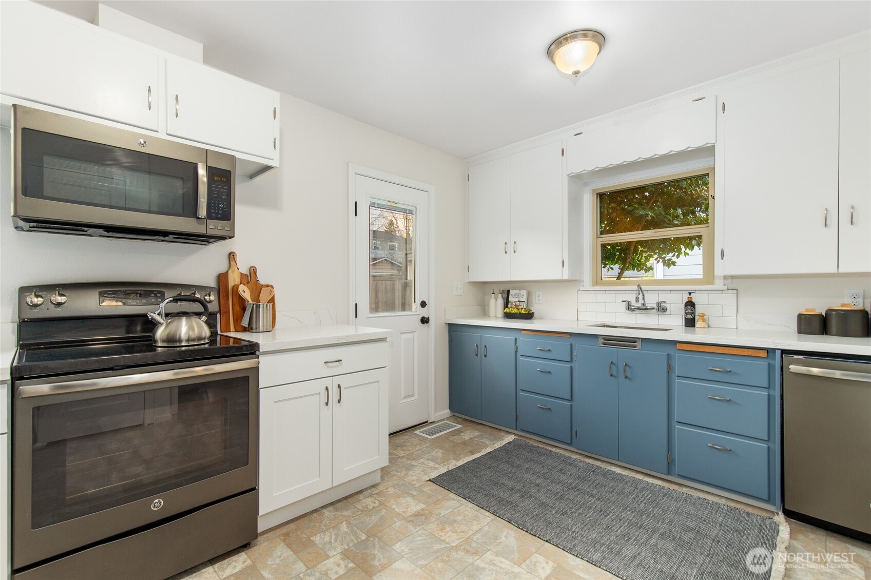 8625 35th Avenue Southwest Seattle, WA 98126 - Photo 10 of 33 a kitchen with a sink stove and microwave