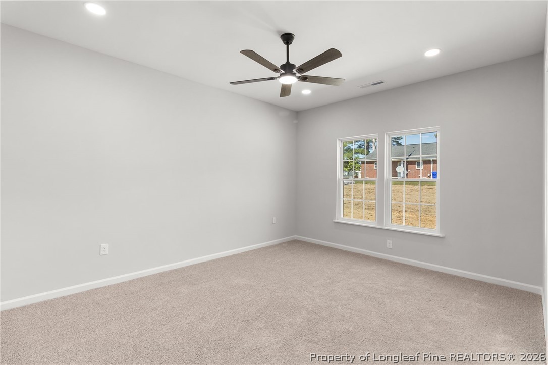 802 Holmes Street Clinton, NC 28328 - Photo 23 of 31 an empty room with a window and a fan
