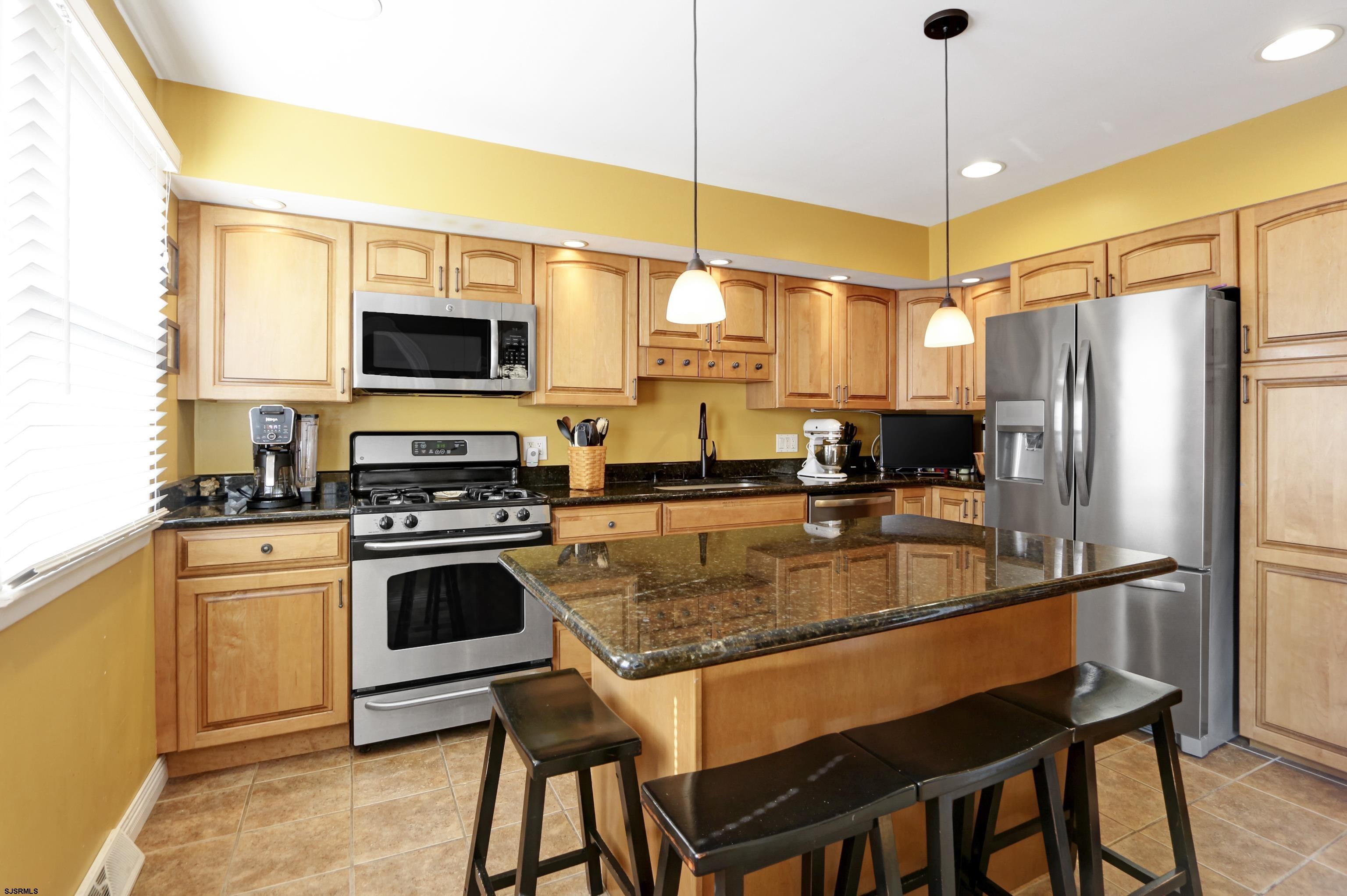 226 Ridgewood Drive Northfield, NJ 08225 - Photo 11 of 41 a kitchen with stainless steel appliances a stove a sink refrigerator and microwave