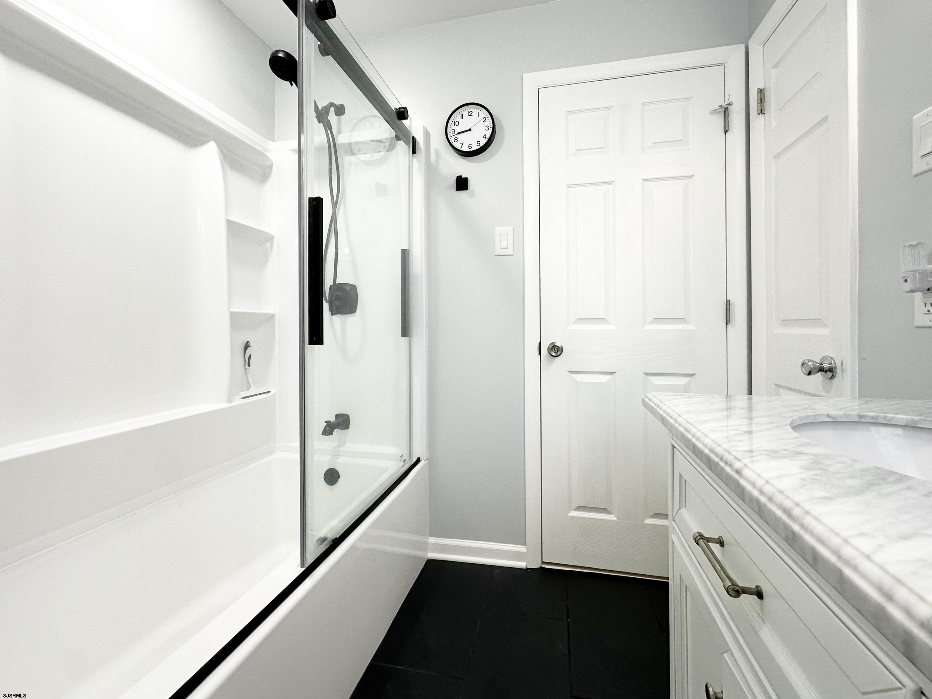 226 Ridgewood Drive Northfield, NJ 08225 - Photo 14 of 41 a bathroom with a granite countertop sink mirror and a bathtub