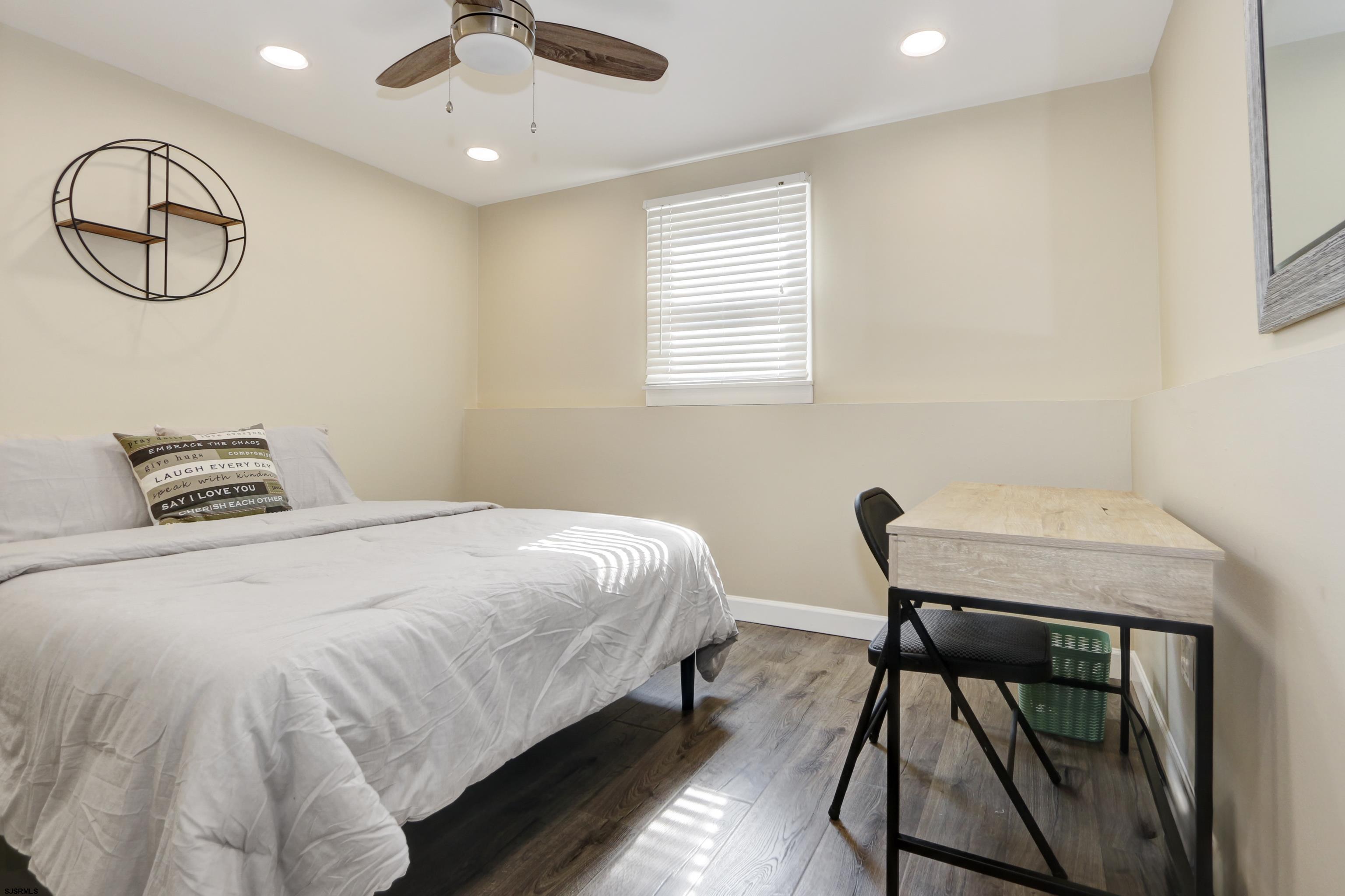 226 Ridgewood Drive Northfield, NJ 08225 - Photo 15 of 41 a bedroom with a bed and a chandelier