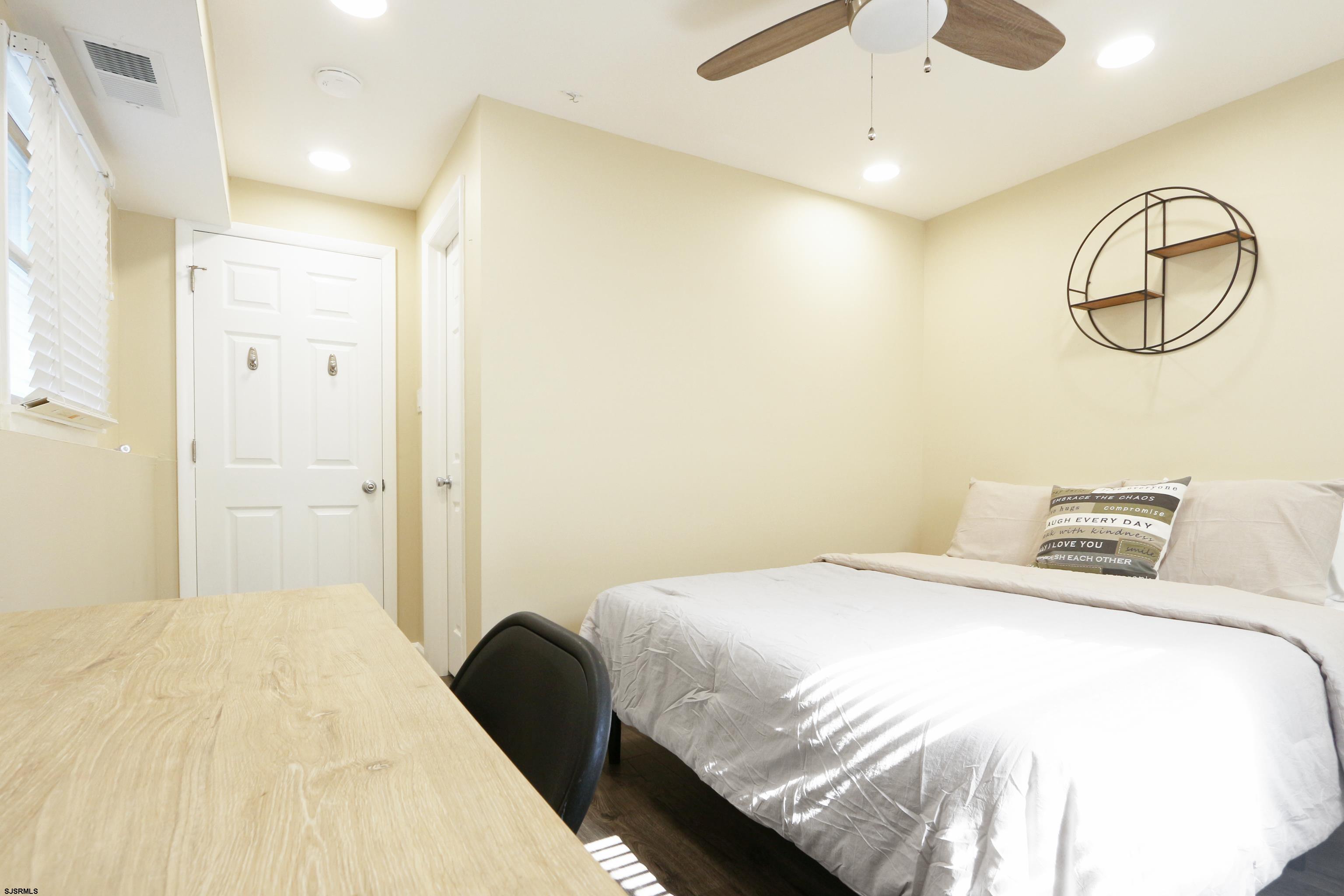 226 Ridgewood Drive Northfield, NJ 08225 - Photo 16 of 41 a bedroom with a bed and a chandelier