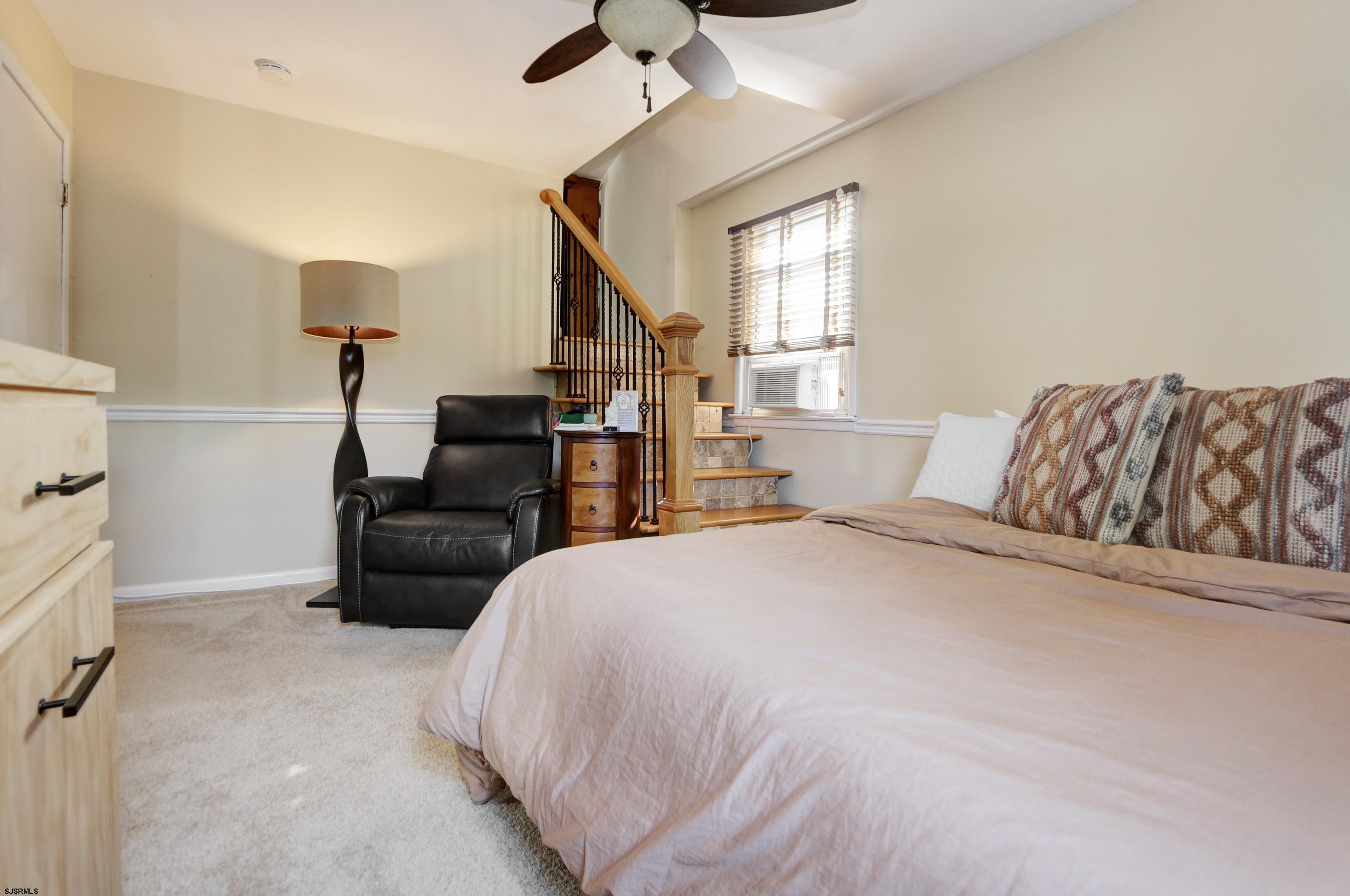 226 Ridgewood Drive Northfield, NJ 08225 - Photo 18 of 41 a spacious bedroom with a bed and a couch