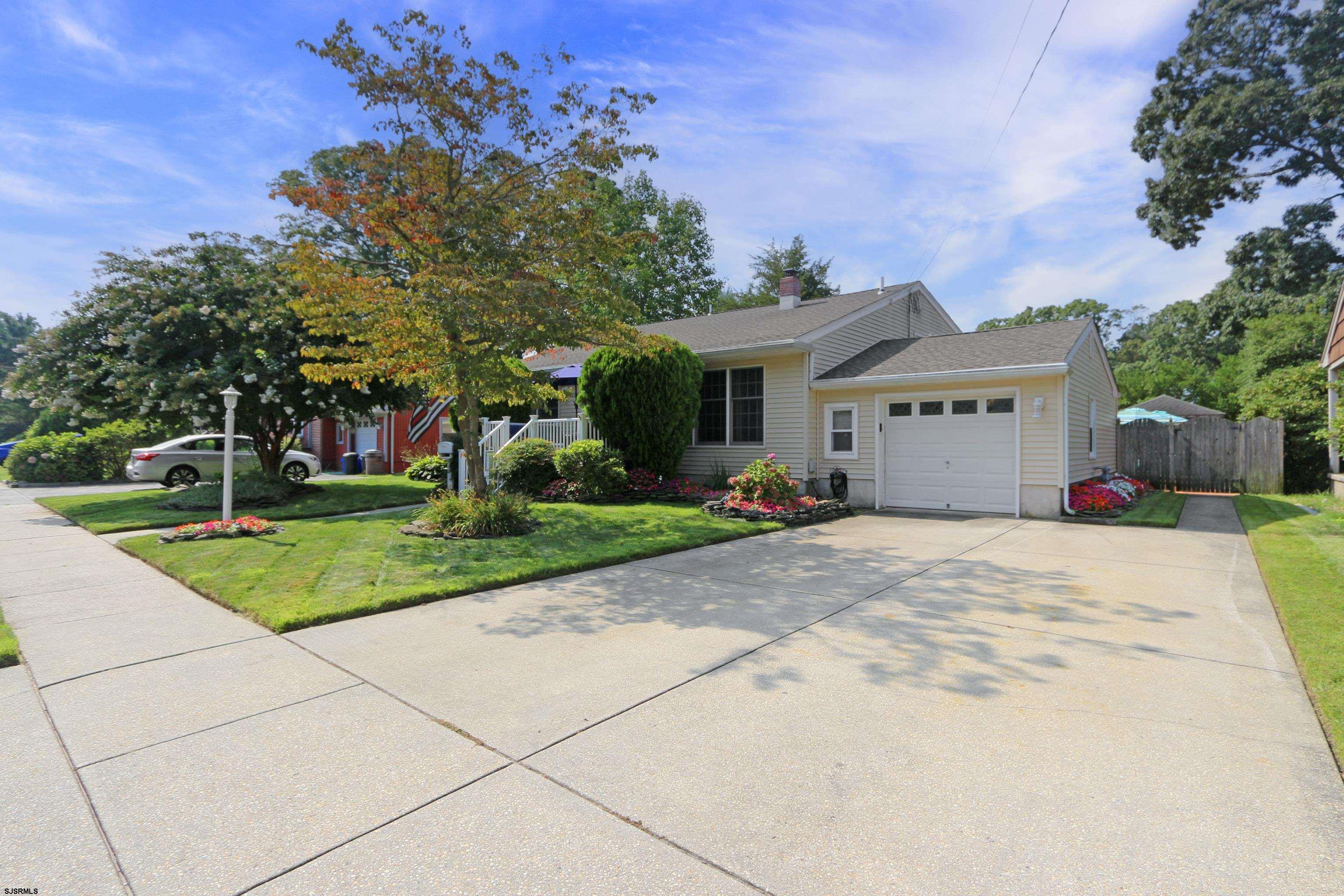 226 Ridgewood Drive Northfield, NJ 08225 - Photo 2 of 41 a front view of a house with a yard and a garage