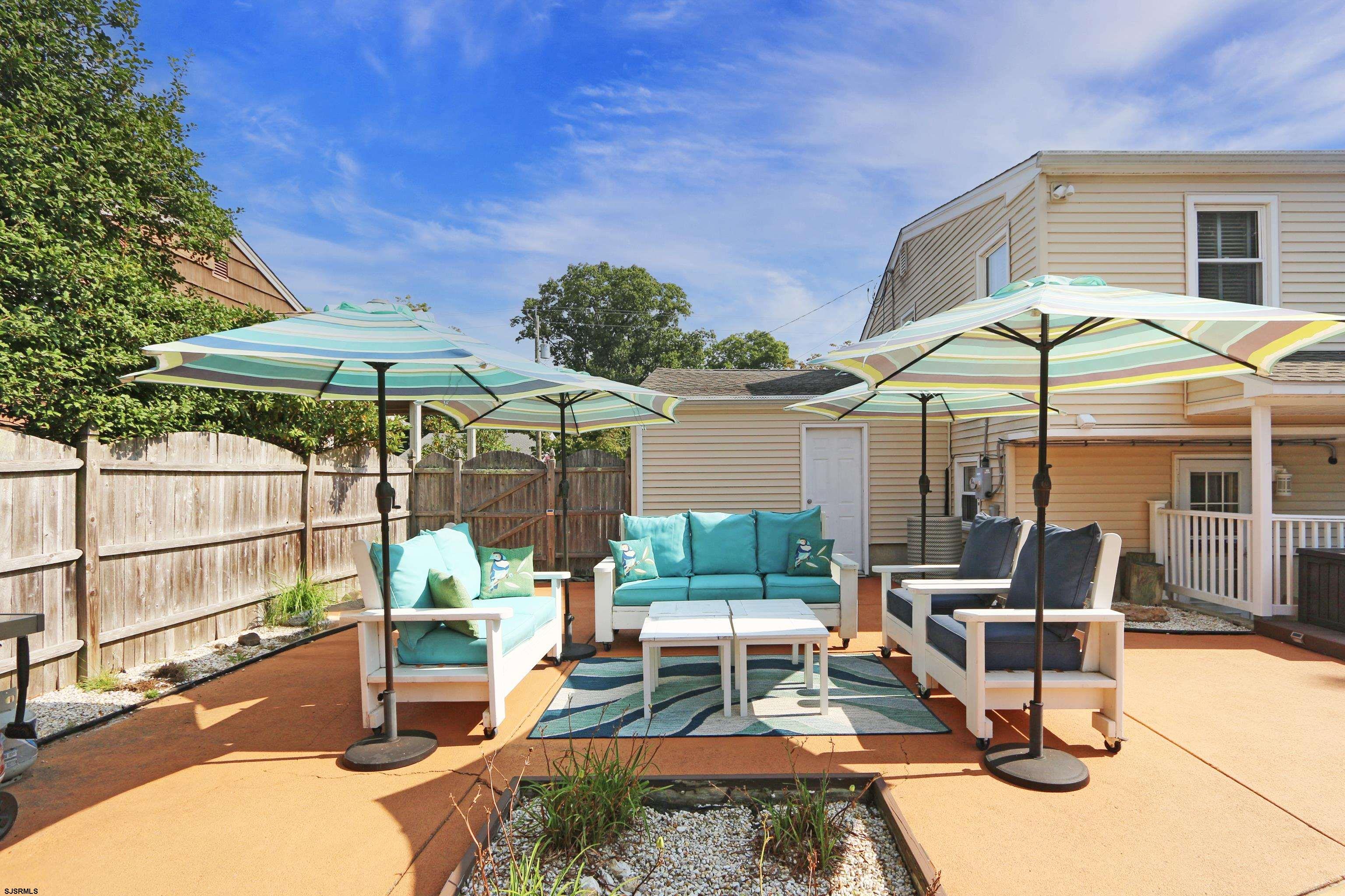 226 Ridgewood Drive Northfield, NJ 08225 - Photo 30 of 41 a view of a chairs and table in backyard