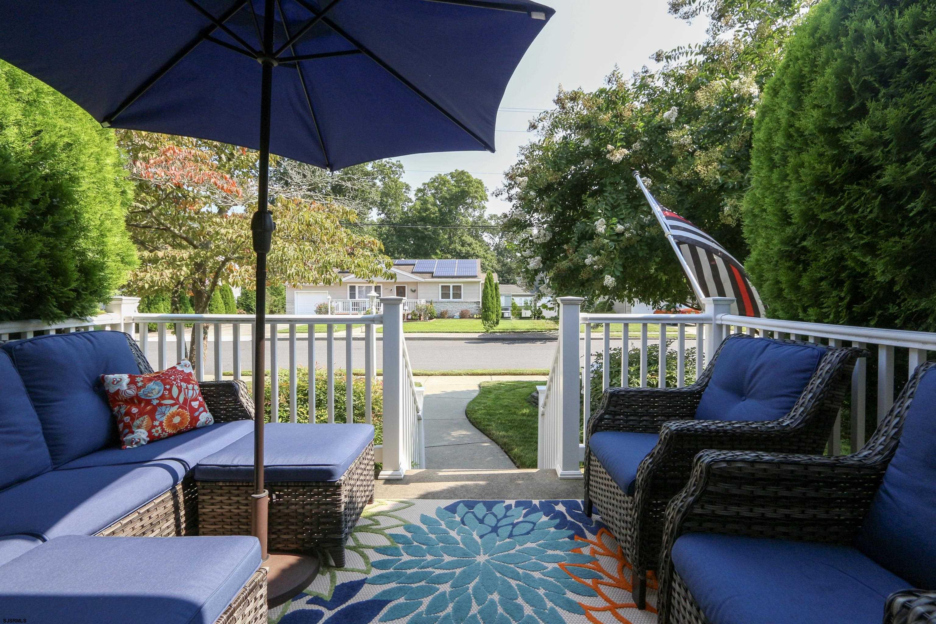 226 Ridgewood Drive Northfield, NJ 08225 - Photo 3 of 41 a view of a chair and tables in the back yard