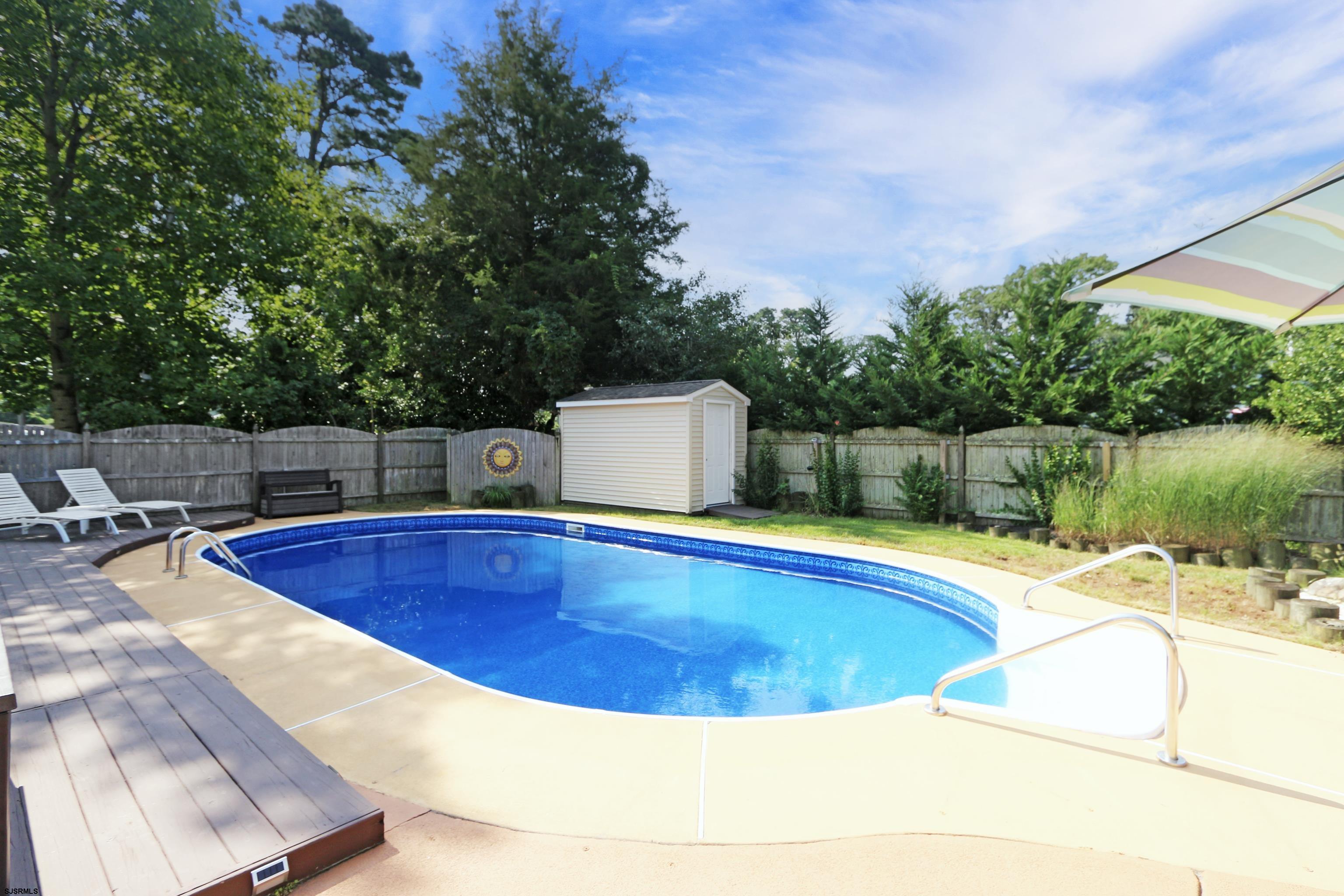 226 Ridgewood Drive Northfield, NJ 08225 - Photo 37 of 41 a view of a swimming pool with a lounge chair