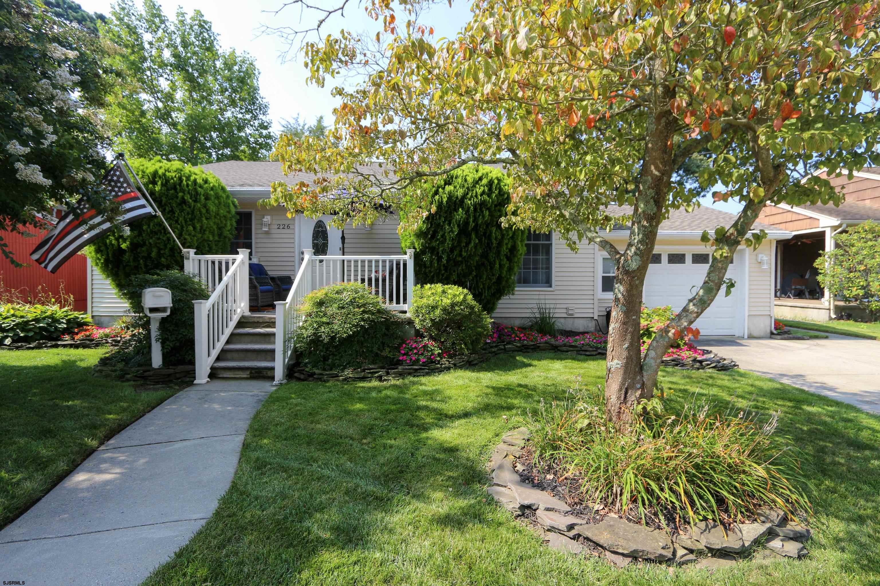 226 Ridgewood Drive Northfield, NJ 08225 - Photo 40 of 41 a front view of a house with garden