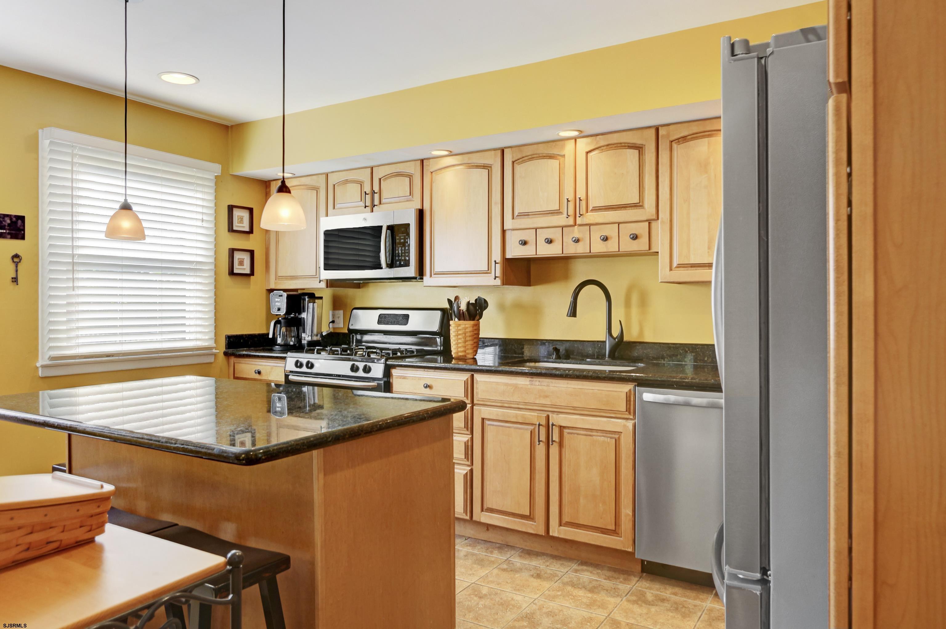 226 Ridgewood Drive Northfield, NJ 08225 - Photo 9 of 41 a kitchen with stainless steel appliances granite countertop a sink a stove and a refrigerator