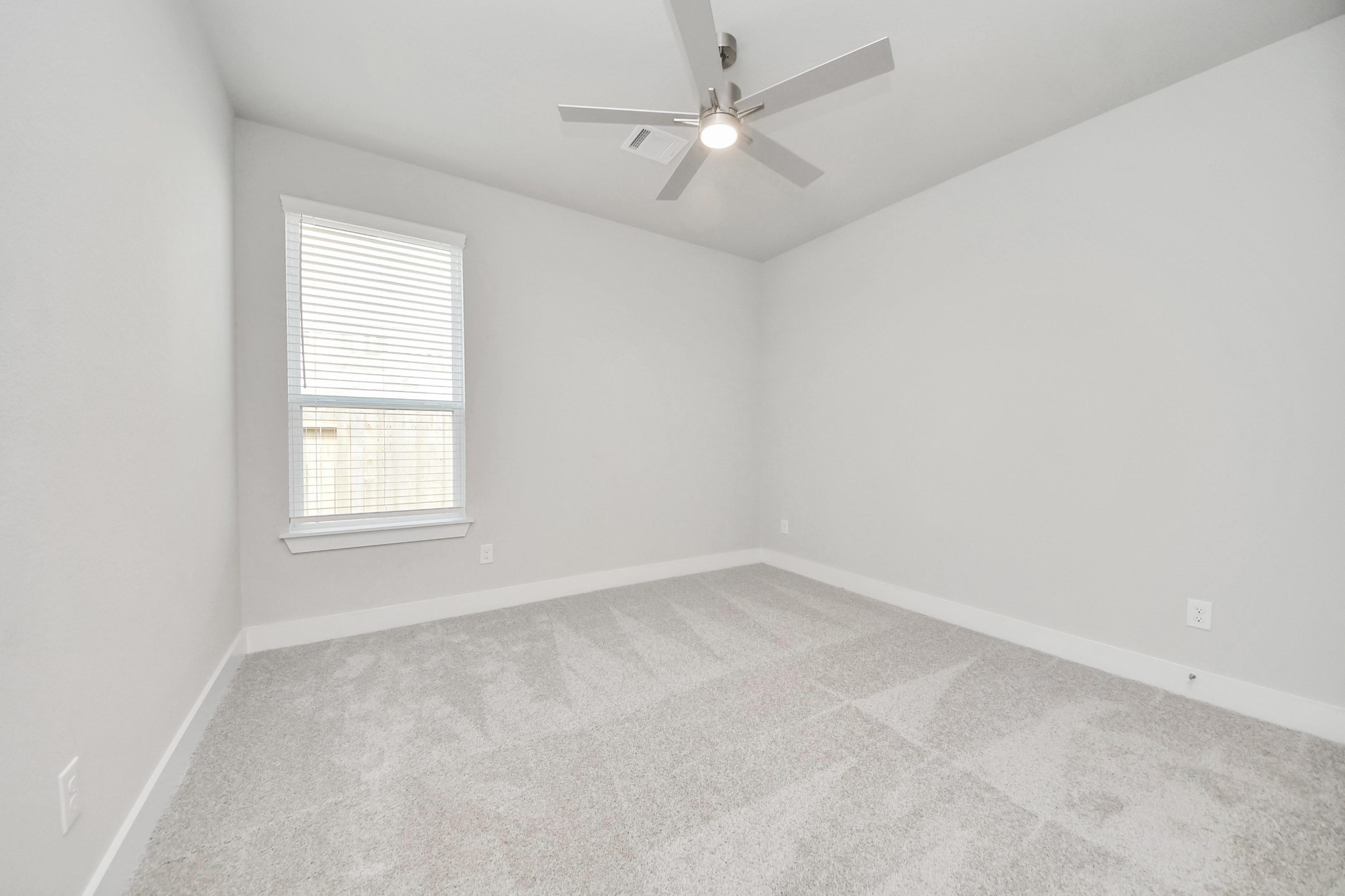 3042 Native Spg Drive Spring, TX 77373 - Photo 9 of 32 Secondary bedroom features plush carpeting, large windows that let in plenty of natural light, bright paint, and spacious closets. Sample photo of completed home with similar floor plan. Actual colors and selections may vary.