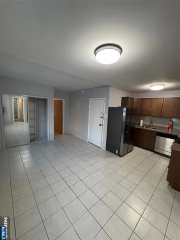 a kitchen with stainless steel appliances a refrigerator a stove a sink and a refrigerator