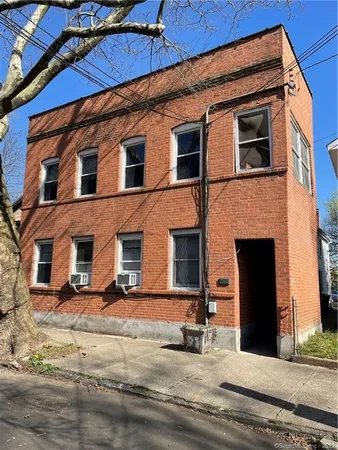 a front view of a house with a road