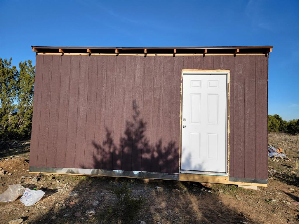 a view of a house with a wooden fence