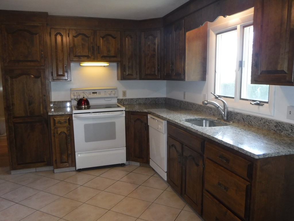 40 Bemis Road Holyoke, MA 01040 - Photo 4 of 29 a kitchen with a sink stove and cabinets