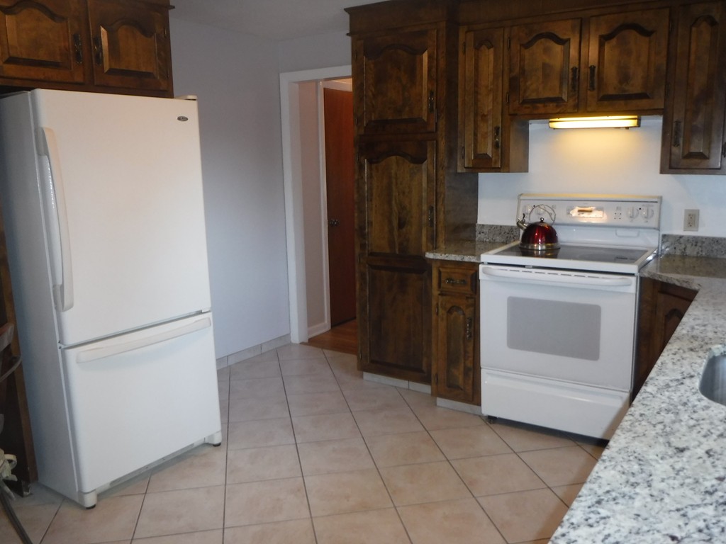 40 Bemis Road Holyoke, MA 01040 - Photo 6 of 29 a kitchen with a stove top oven and refrigerator