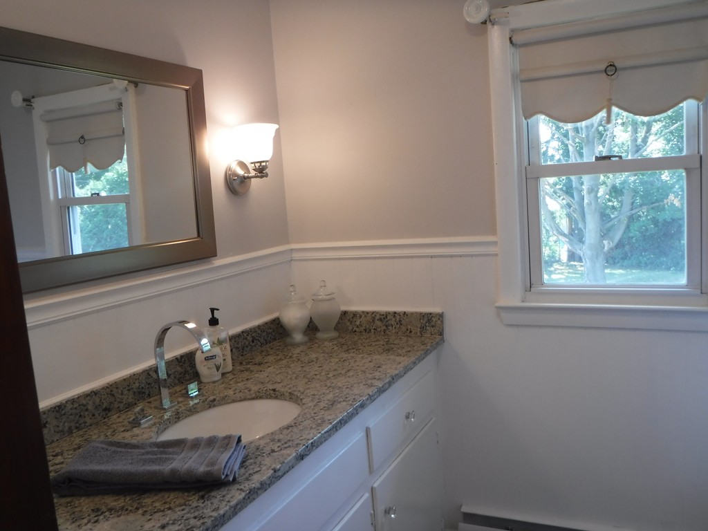 40 Bemis Road Holyoke, MA 01040 - Photo 9 of 29 a bathroom with a granite countertop sink and a mirror